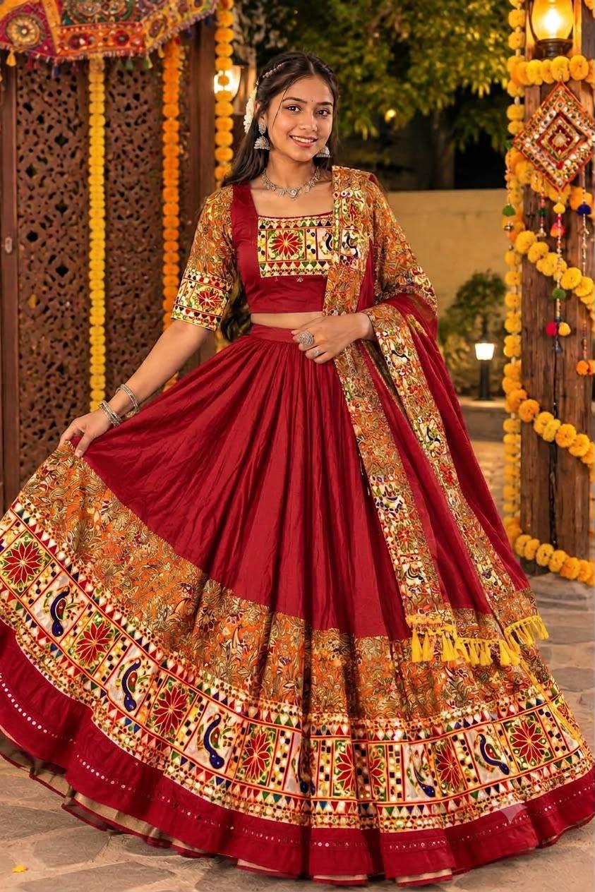 Woman in a maroon chaniya choli with a peacock and floral mirror border